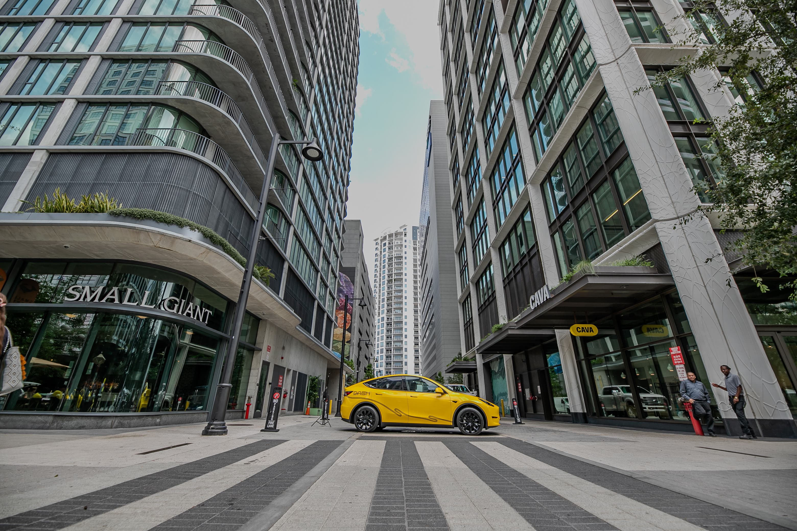 Yellow Tesla in between local shops in Downtown Tampa