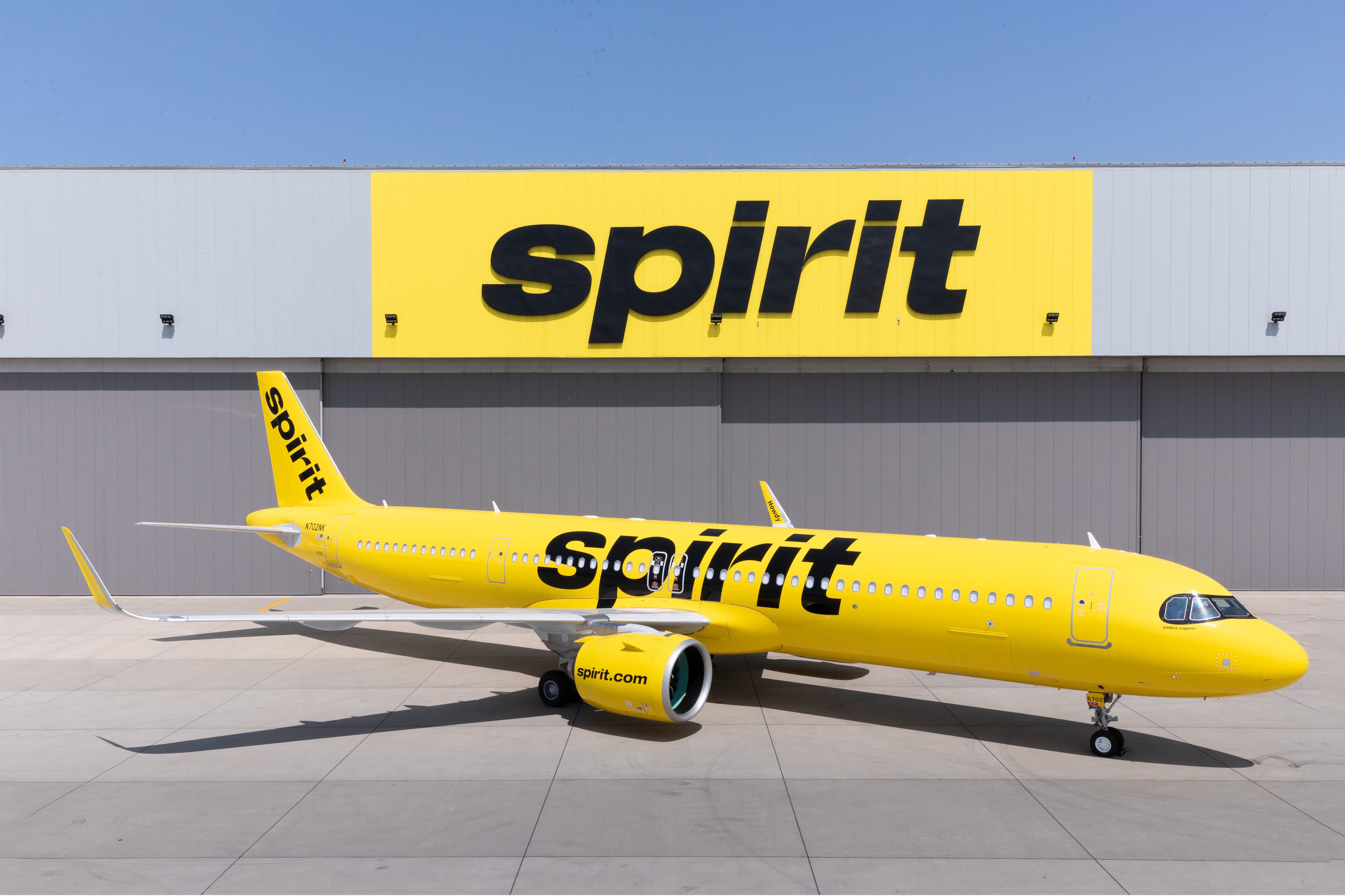 Big yellow plane with black letters saying Spirit on it.