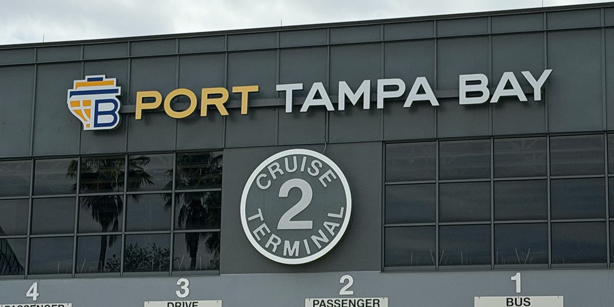Port Tampa Bay Cruise Terminal 2 exterior signage at 651 Channelside Drive, with numbered passenger drop-off zones visible